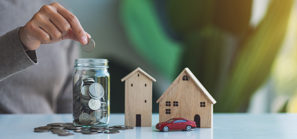 Knowing Your Assets Before Marriage Matters — Especially for High-Net-Worth Individuals, image of house, car, and money jar on a table.